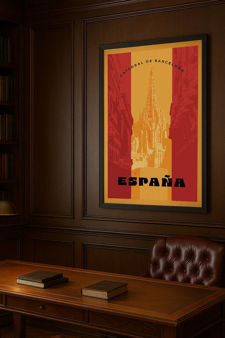 Framed poster of a cathedral with 'España' text on a wooden wall above a desk.