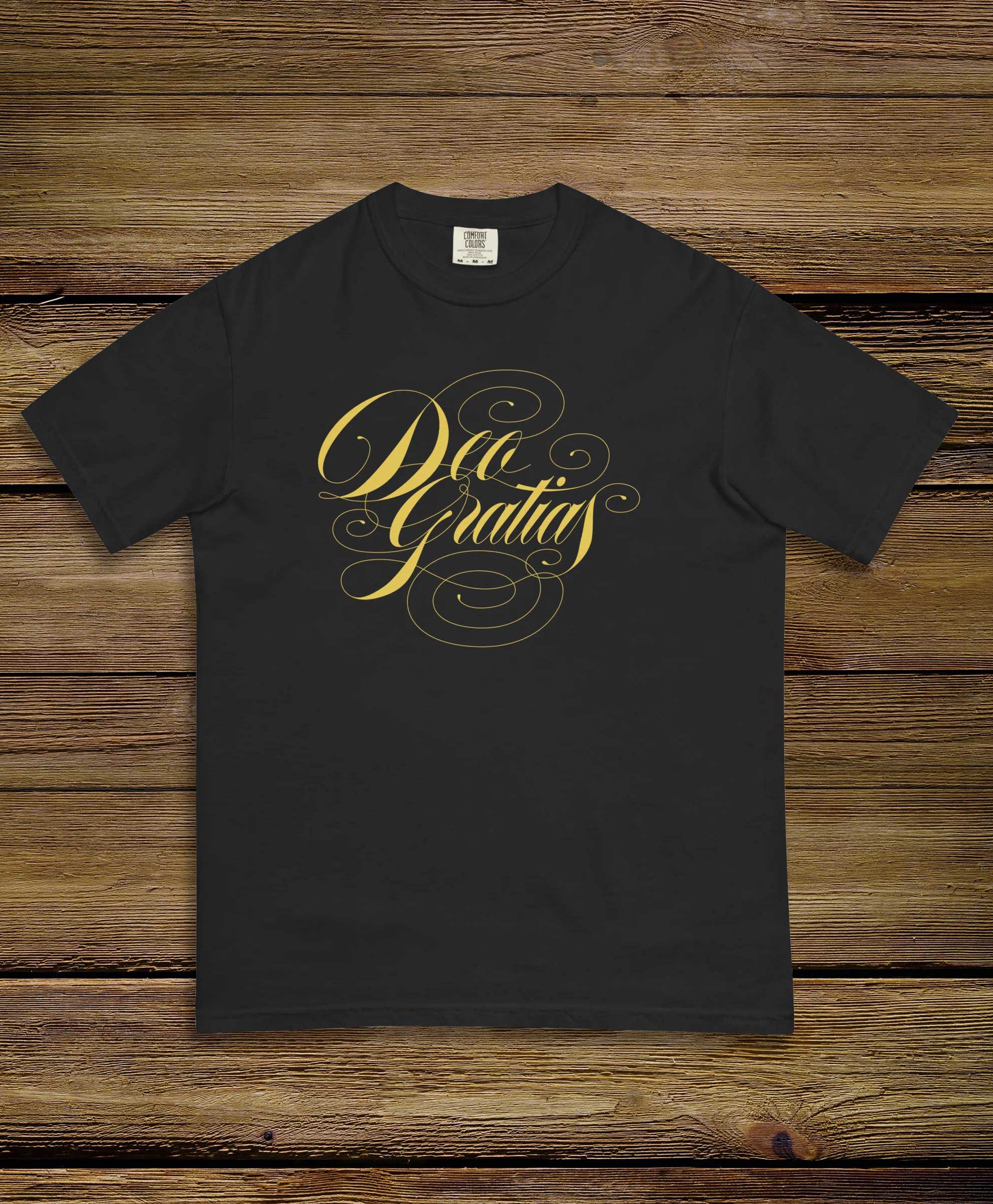 Deo Gratias Tshirt on wooden background